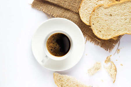 Black coffee and whole wheat bread for breakfast on white backgroundの写真素材