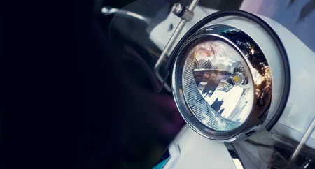 Colorful headlight of scooter on dark backgroundの写真素材