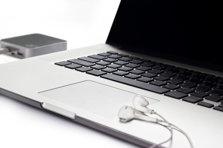 Laptop and earphone on white backgroundの写真素材