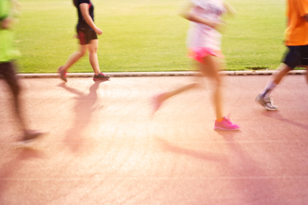 Blurred colorful people jogging on the racetrack, soft and blur conceptの写真素材