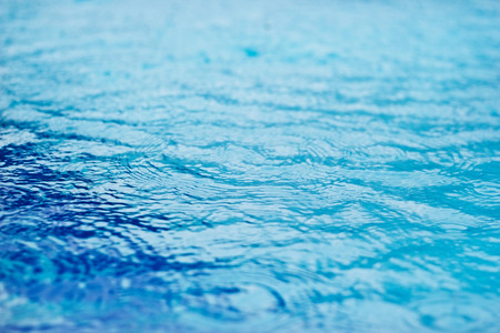 Raining drops in the swimming pool, soft focus and blur for backgroundの写真素材