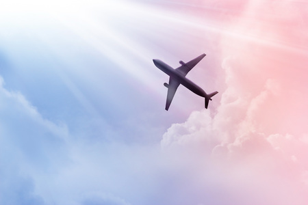Airplane in the sky and cloud colorful at sunsetの写真素材