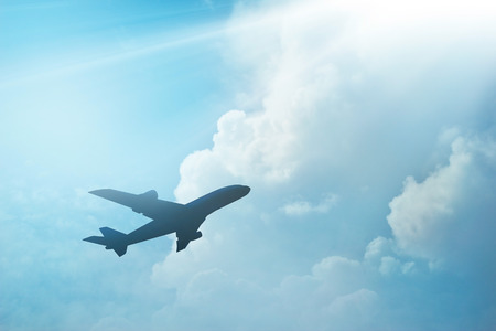Airplane in the sky and cloud at sunsetの写真素材