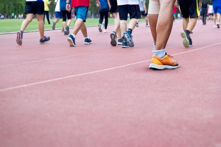 a lot of people walk excercise on runing track background, blank textの写真素材
