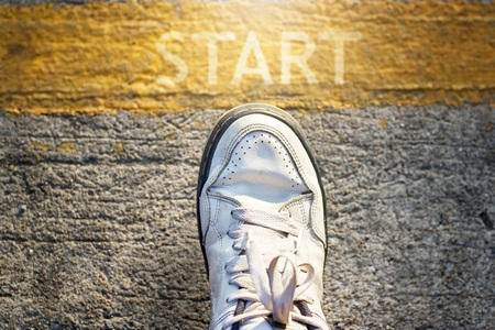 Man is steping up to start his life, work, fight all is on word startの写真素材