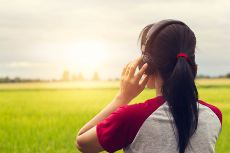 Freedom woman enjoying music with headphones outdoorsの写真素材