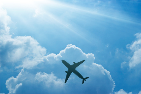 Airplane in the blue sky and cloud at sunriseの写真素材