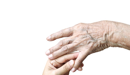 Daughter touching  elderly mom hand for take care of and make relationship each other.の写真素材