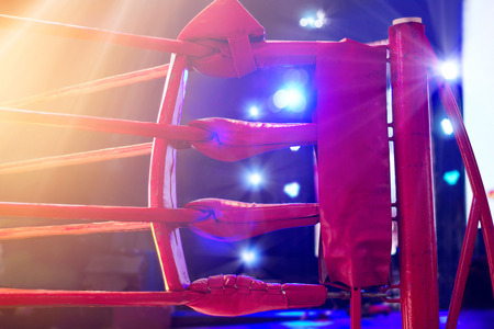 Boxing ring red corner and floodlights, dramatic lightingの写真素材