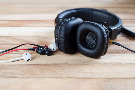 headphones and earphones on grunge wooden backgroundの写真素材