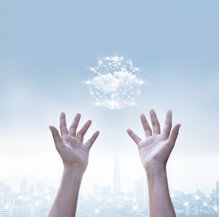 Abstract of business cloud computing circle global network connection over human  hands on blue sky, metropolis backgroundの写真素材