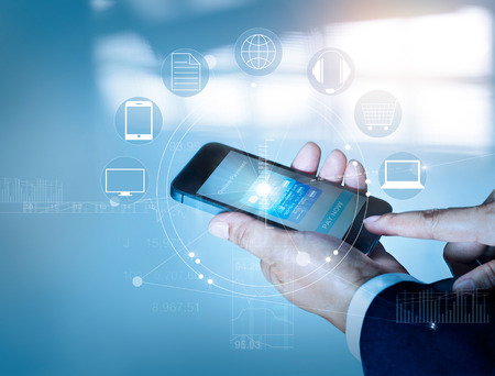 Businessman using mobile payments online shopping and icon customer network connection on screen, m-banking and omni channelの写真素材