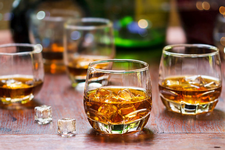 whiskey drinks with ice on wooden backgroundの写真素材