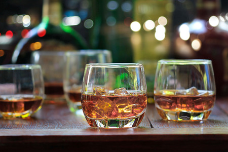 whiskey drinks with ice on wooden backgroundの写真素材