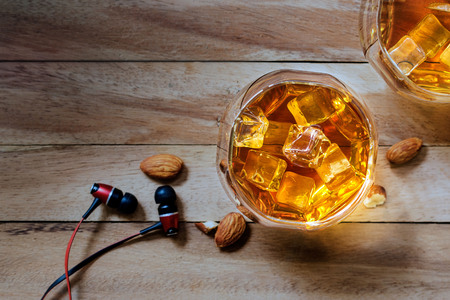 whiskey drinks with ice on wooden backgroundの写真素材