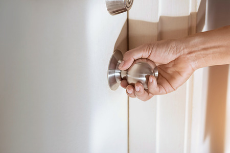 woman hand holding a doorknobの写真素材