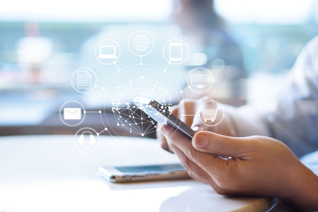 Man using mobile payments, holding circle global and icon customer network connection, Omni Channelの写真素材