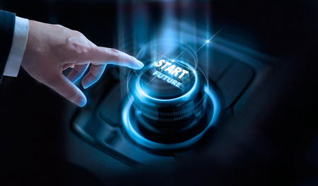 Businessman press start future button with virtual light in dark backgroundの写真素材