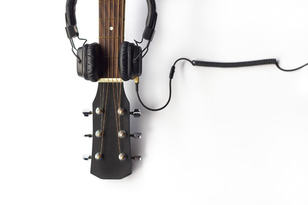 Guitar and headphone on the white background