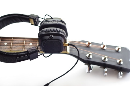 Guitar and headphone on the white backgroundの写真素材