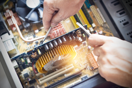 hands with tools for repair computerの写真素材