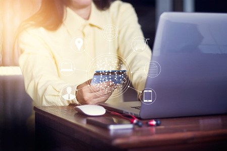 Woman using laptop payments online shopping and icon customer network connection, m-banking and omni channelの写真素材