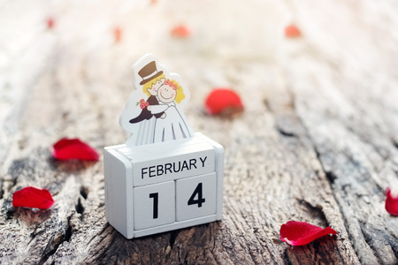 Valentine's day text on wooden with red heartsの写真素材