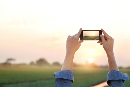 Woman photography rural prairie in sunset, relax timeの写真素材
