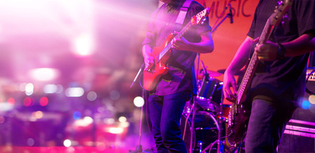 Guitarist and colorful lighting on a stage, soft focusの写真素材