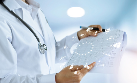 Medicine doctor and medical Report in hand with icon medical network connection in hospital background, medical technology network conceptの写真素材