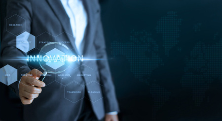 Innovation concept, businessman holding magnifying glass and search word business on interface screenの写真素材