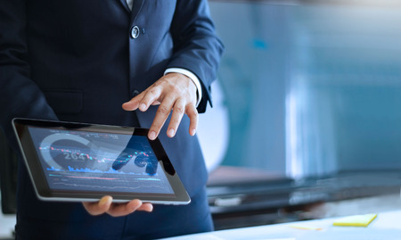 Analyzing data, Businessman working and checking market data in office, hand pointing on the data...