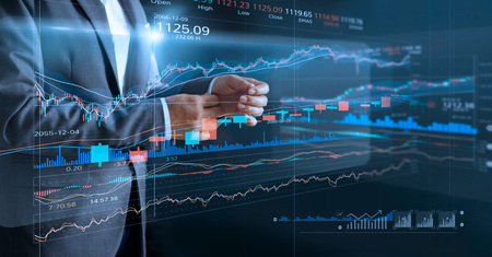 Businessman with virtual screen and data statistic index graph, analysis graph of stock market...