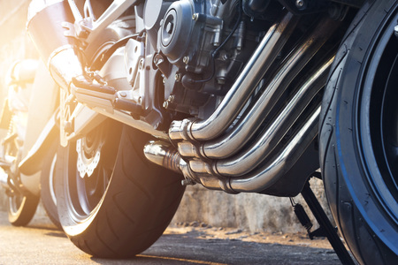 Modern motorcycle and exhaust details parking on the street backgroundの写真素材