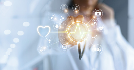 Medicine doctor and stethoscope in hand touching icon medical network connection with modern virtual screen interface, medical technology network conceptの写真素材