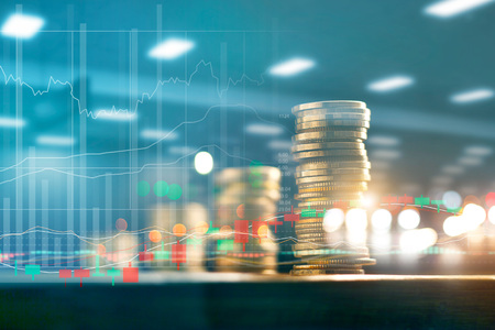 Finance and business investment concept. Graph and rows with statistic growth of coins on table. Finance and business investment concept. Graph and rows with statistic growth of coins on table.