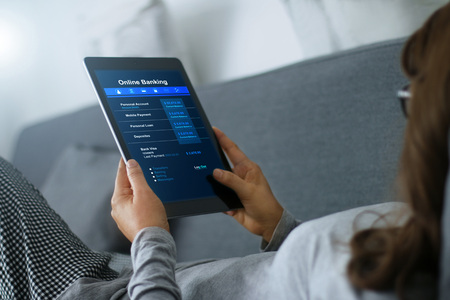 Woman using tablet for online banking technology at home, modern lifestyle on internetの写真素材