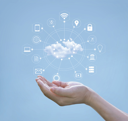 Cloud computing concept. Hands holding of cloud computing and icon network connection on blue sky. Technology of storage futuristic.の写真素材