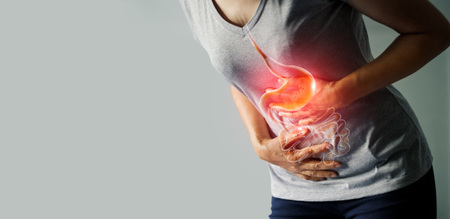 Woman touching stomach painful suffering from stomachache causes of menstruation period, gastric ulcer, appendicitis or gastrointestinal system desease. Healthcare and health insurance conceptの写真素材