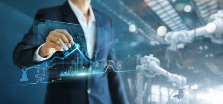 Manager engineer analyzing and control automation robot arms machine on software modern virtual...