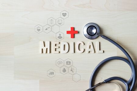 Medical and healthcare concept, Stethoscope and wooden word medical with healthcare icon and medicine for hospital and Health Insurance.の写真素材