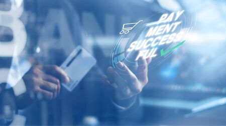 Woman holding credit card and using mobile smart phone with word payment successful, online payment,...