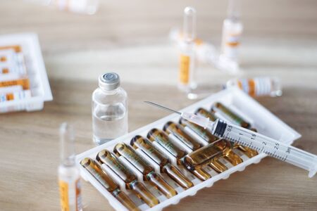 Medicine and syringe on table