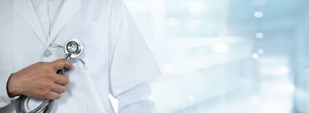 Medical technology and healthcare business, Cardiologist doctor with stethoscope in hand on the hospital background.の写真素材