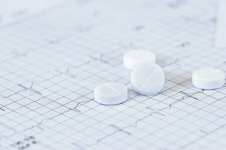 Medicine of cardiologist and nitroglycerin on heart rate checking  report paper's patient diagnosising of doctor on table work.の写真素材