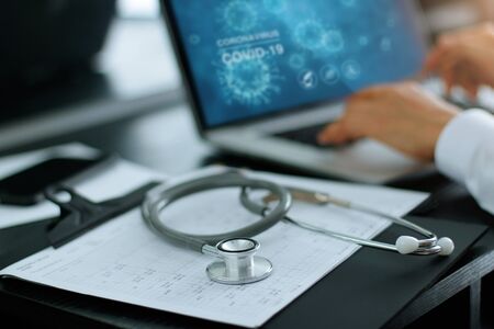 Stethoscope medical and doctor analysis coronavirus or covid-19 data on laptop computer on laboratory background.の写真素材