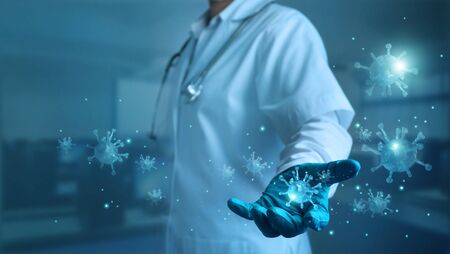 Abstract healthcare, Covid-19, Medicine doctor with stethoscope holding corona virus in hand and virus spreading on blue background, Coronavirus outbreaking and global epidemic virus .の写真素材