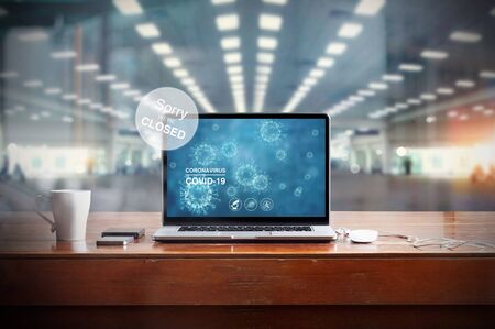Economic crisis, Image of coronavirus on laptop screen and displaying the message
