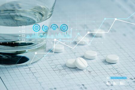 Health care and Medical, Patients' pills and water glass placed on a heartbeat report paper And a...