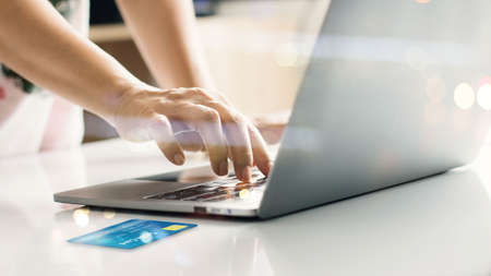 Hands online shopping with credit card on laptop. Raising of e commerce develop secure payment...
